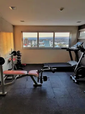 a gym with two tread machines and a window at Departamento en Carlos Paz con vistas y céntrico in Villa Carlos Paz