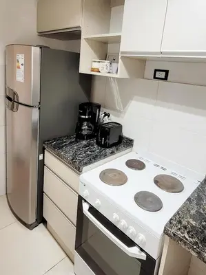 a kitchen with a white stove and a refrigerator at Departamento en Carlos Paz con vistas y céntrico in Villa Carlos Paz