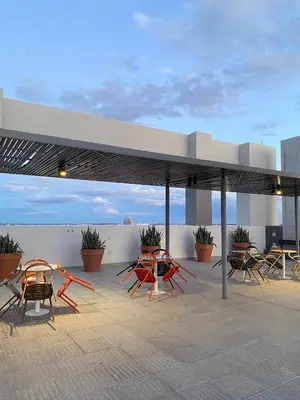 a group of tables and chairs under a pavilion at Dpto Premium en Torre Cofico con cochera incluida - Pileta en Terraza in Cordoba