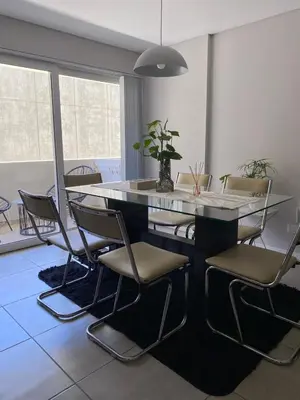 a dining room with a table and chairs at Dpto Premium en Torre Cofico con cochera incluida - Pileta en Terraza in Cordoba