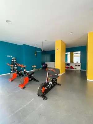 a gym with three exercise bikes in a room at Dpto Premium en Torre Cofico con cochera incluida - Pileta en Terraza in Cordoba