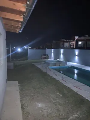 an empty swimming pool at night with lights at Soligna-alquiler in Villa Santa Cruz del Lago