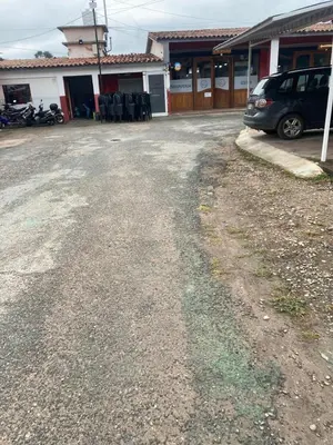 a dirt road with a car parked in front of a house at Soligna-alquiler in Villa Santa Cruz del Lago