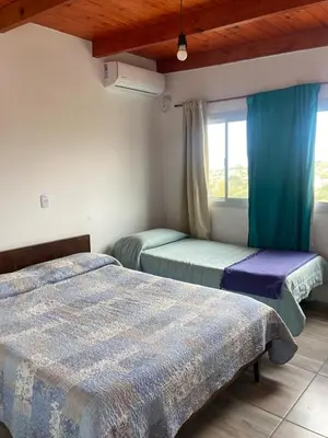 a bedroom with two beds and a window at Soligna-alquiler in Villa Santa Cruz del Lago