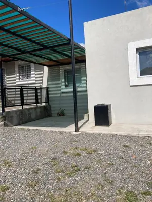 a building with awning on the side of it at Soligna-alquiler in Villa Santa Cruz del Lago