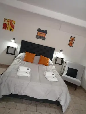 a bedroom with a large bed with two towels on it at Balcón al Tajamar in Alta Gracia
