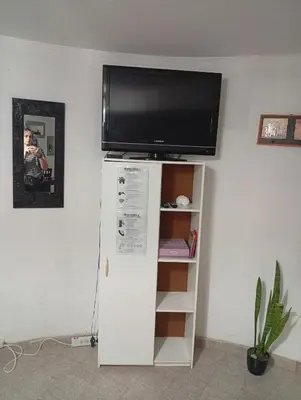 a flat screen tv sitting on top of a white cabinet at Balcón al Tajamar in Alta Gracia