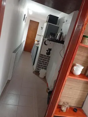 a stairway leading to a room with a kitchen at Balcón al Tajamar in Alta Gracia
