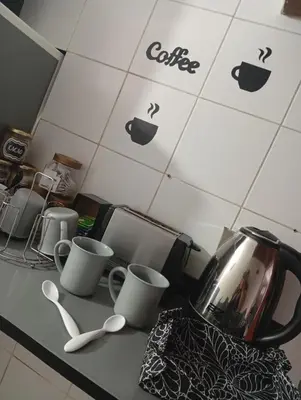 a kitchen counter with cups and spoons on it at Balcón al Tajamar in Alta Gracia