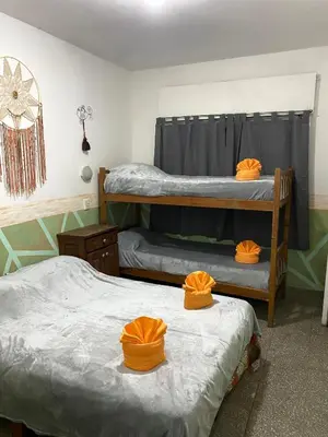 two bunk beds in a room with orange hats on them at Antu Kuyen Hostel in Villa Carlos Paz