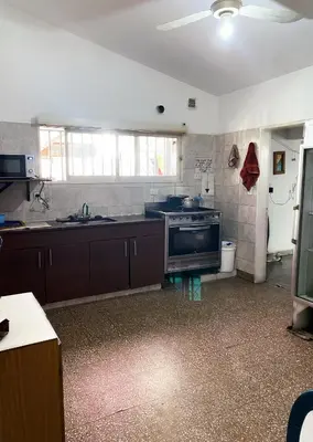 a kitchen with a stove and a sink at Antu Kuyen Hostel in Villa Carlos Paz