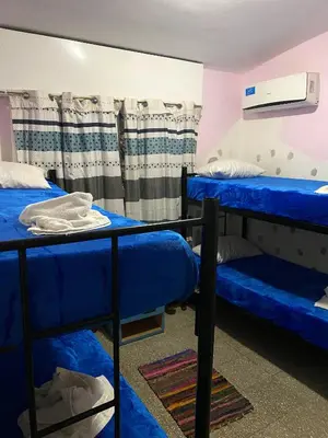 a room with two blue bunk beds in it at Antu Kuyen Hostel in Villa Carlos Paz