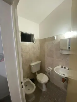 a small bathroom with a toilet and a sink at Antu Kuyen Hostel in Villa Carlos Paz