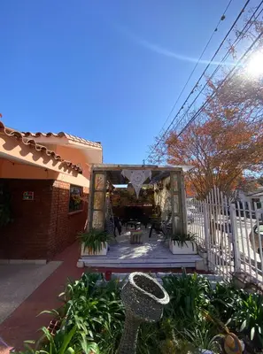 a porch of a house with a white fence at Antu Kuyen Hostel in Villa Carlos Paz