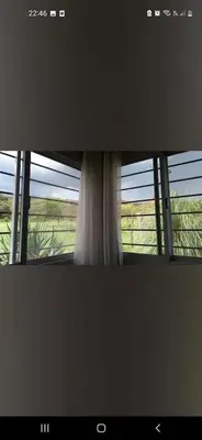 a view of a window with a white curtain at Casa en las sierras de córdoba in Tanti