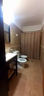 a bathroom with a toilet and a sink at Casa en las sierras de córdoba in Tanti