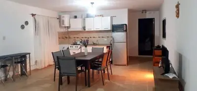a kitchen with a table and chairs in a room at Casa en las sierras de córdoba in Tanti