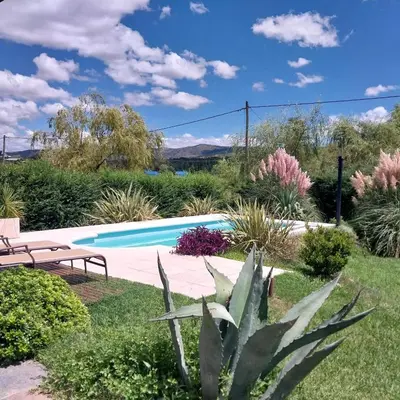 a garden with a swimming pool and plants at Casa en las sierras de córdoba in Tanti