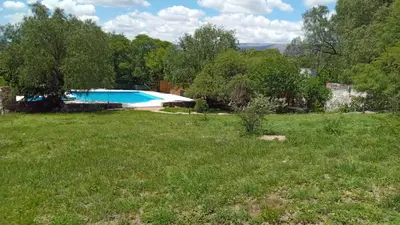 a view of a yard with a swimming pool at APART HOTEl ACUARELA in Mina Clavero