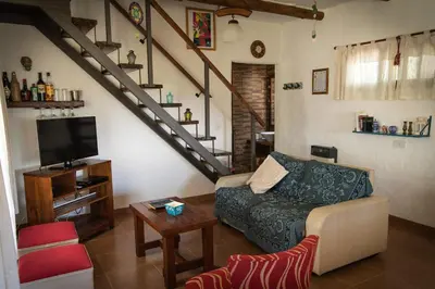 a living room with a couch and a staircase at Colores de Panaholma in Panaholma