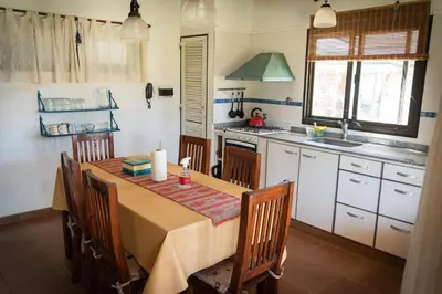 a kitchen with a table with chairs and a sink at Colores de Panaholma in Panaholma