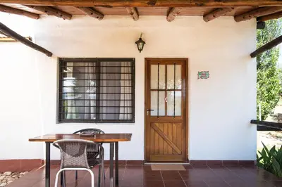 a porch with a wooden door and a table and chairs at Colores de Panaholma in Panaholma