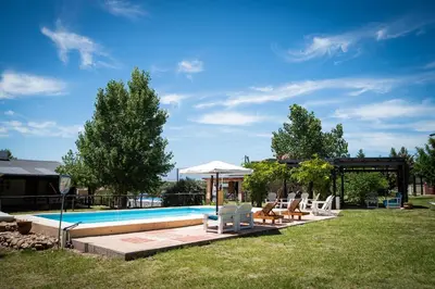 a swimming pool with a group of chairs and umbrellas at Colores de Panaholma in Panaholma