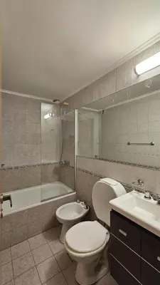 a bathroom with a toilet and a tub and a sink at Paraná 640 in Cordoba