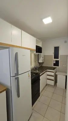 a kitchen with a white refrigerator and a stove at Paraná 640 in Cordoba