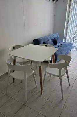 a white table and two chairs and a blue couch at Paraná 640 in Cordoba