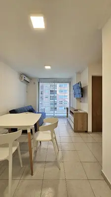 a living room with a table and a tv at Paraná 640 in Cordoba
