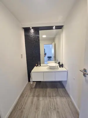 a bathroom with a sink and a mirror at Casa con hermosa vista al lago in Villa Carlos Paz