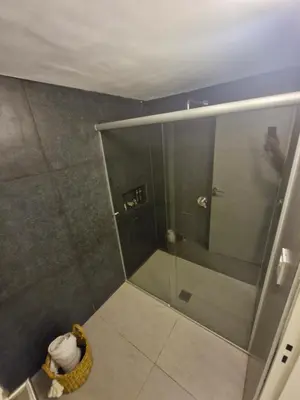 a shower stall with a glass door in a bathroom at Casa con hermosa vista al lago in Villa Carlos Paz