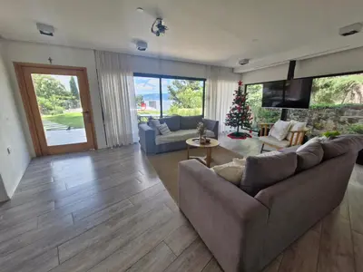a living room with a couch and a christmas tree at Casa con hermosa vista al lago in Villa Carlos Paz