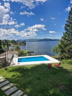 a swimming pool with a view of the water at Casa con hermosa vista al lago in Villa Carlos Paz