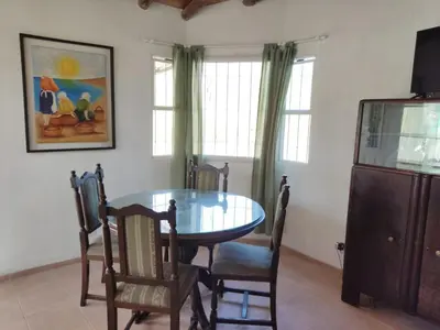 a dining room with a glass table and chairs at Cabana Cecilia in Villa Icho Cruz