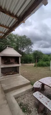 a shelter with a table and a picnic table at Cabana Cecilia in Villa Icho Cruz