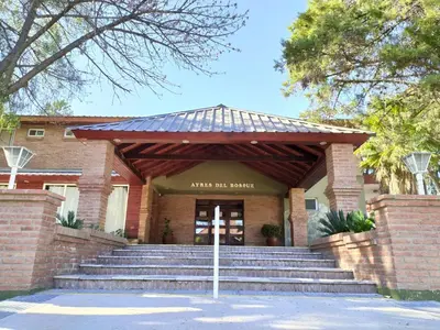 a building with steps leading up to the entrance at Ayres del Bosque in Merlo