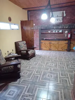 a living room with a couch and a chair at Lo de iaia in Carpintería