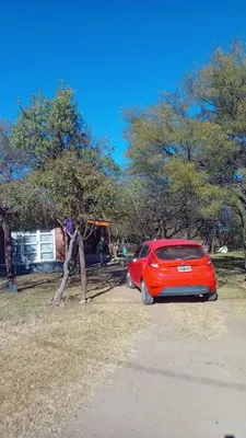 a red car parked next to a tree at Lo de iaia in Carpintería