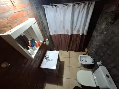 a bathroom with a sink and a toilet and a shower at Lo de iaia in Carpintería
