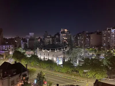 a city at night with a street and buildings at Departamento Amoblado in Cordoba
