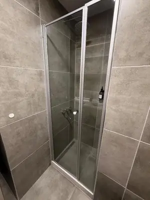 a shower with a glass door in a bathroom at Departamento Elegante y Funcional SS10 in Cordoba