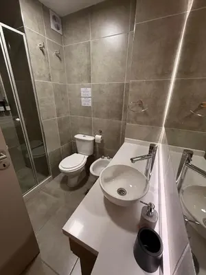 a bathroom with a sink and a toilet and a shower at Departamento Elegante y Funcional SS10 in Cordoba