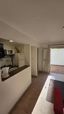a room with a kitchen and a living room at Dpto zona NUEVO CENTRO shopping y PATIO OLMOS in Cordoba