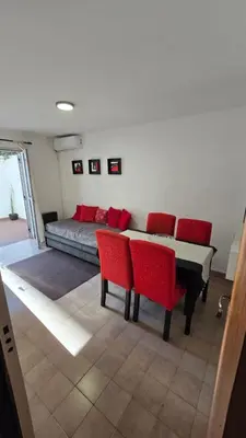 a room with a bed and a table and chairs at Dpto zona NUEVO CENTRO shopping y PATIO OLMOS in Cordoba