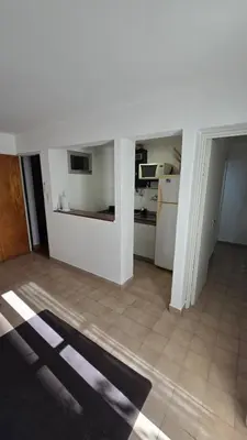 a white room with a kitchen and a floor at Dpto zona NUEVO CENTRO shopping y PATIO OLMOS in Cordoba