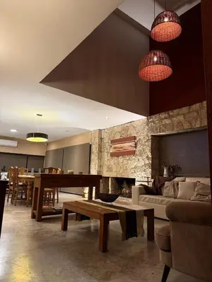 a living room with a table and a dining room at Sobre lago Los Molinos in Villa Anizacate