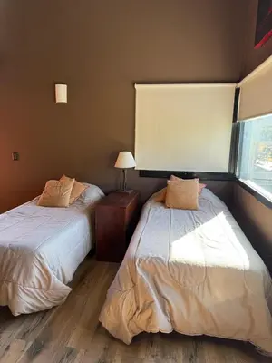 a bedroom with two beds and a window at Sobre lago Los Molinos in Villa Anizacate