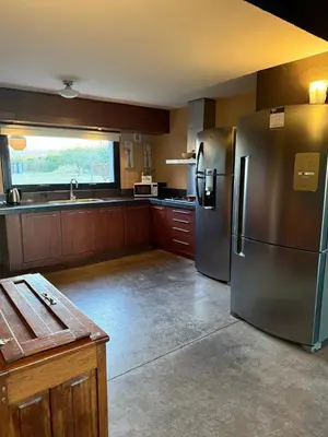 a kitchen with stainless steel refrigerators and a sink at Sobre lago Los Molinos in Villa Anizacate